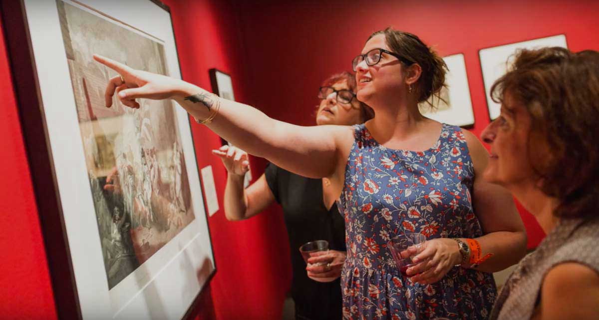 Bailey Harper &rsquo;19 pointing at a photo in The Plains of Mars exhibition