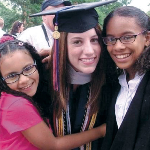 Rachel Rutter &rsquo;11 at Commencement with two El Centro kids