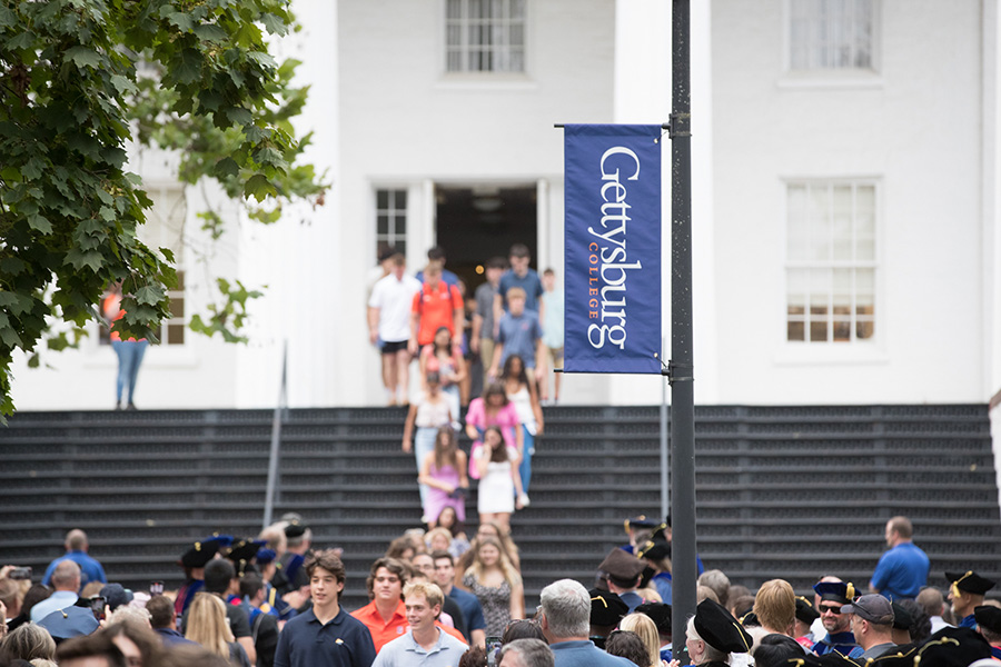 students walk through the south entrance to Penn Hall