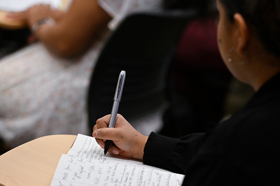 A student takes notes during class