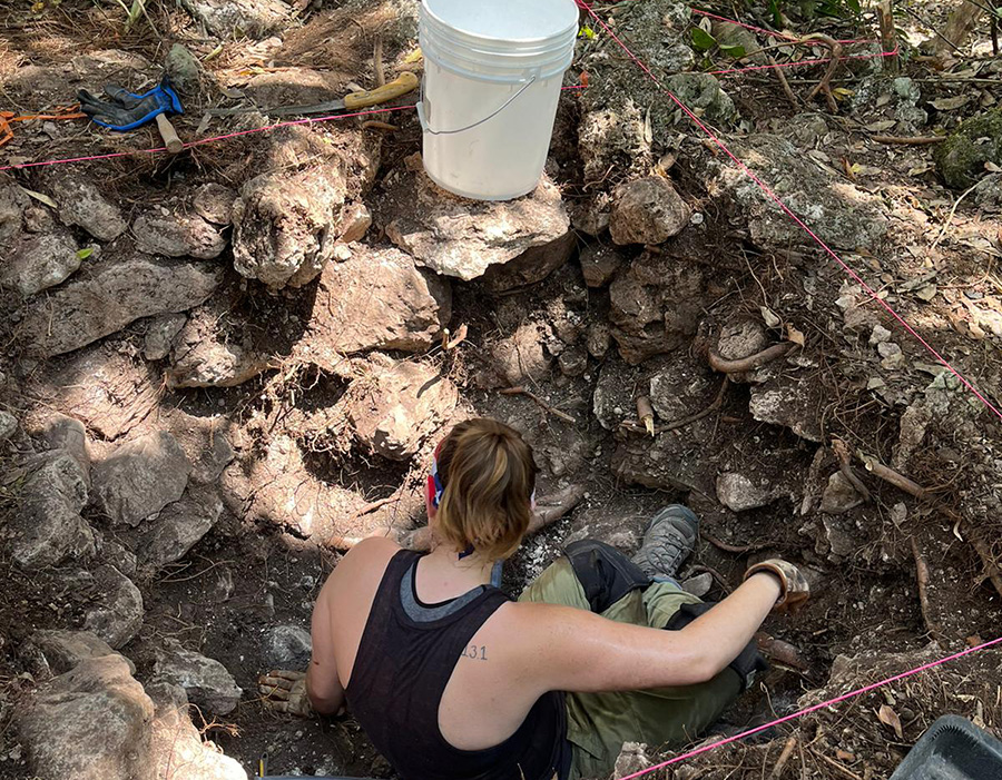 Kayla Tursack ’25 excavating a test pit