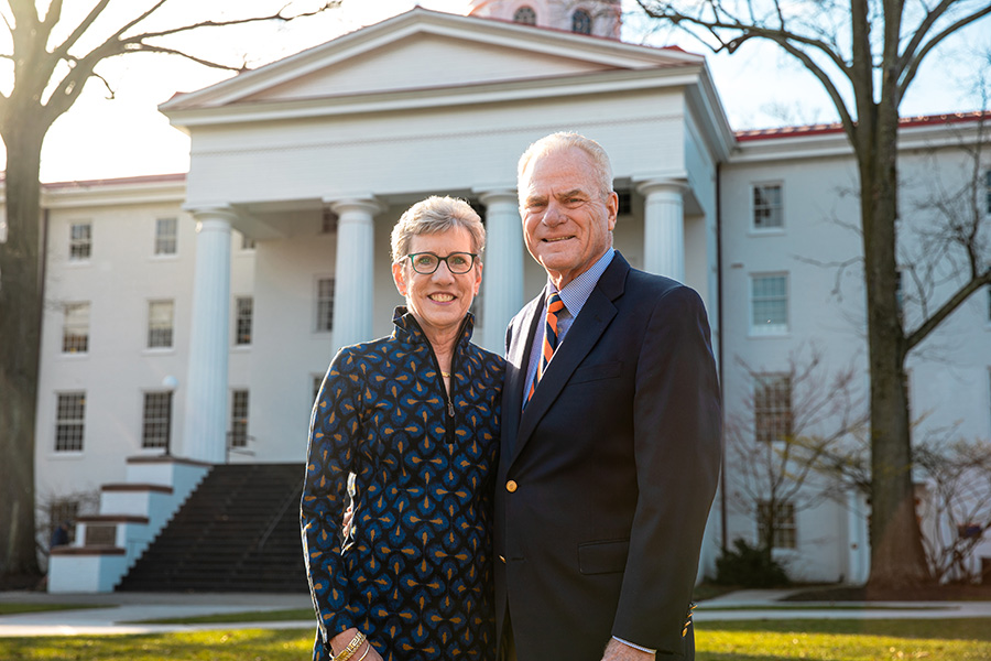 Joan &rsquo;76 and Rick Schweizer &rsquo;76 pose in front of Penn Hall