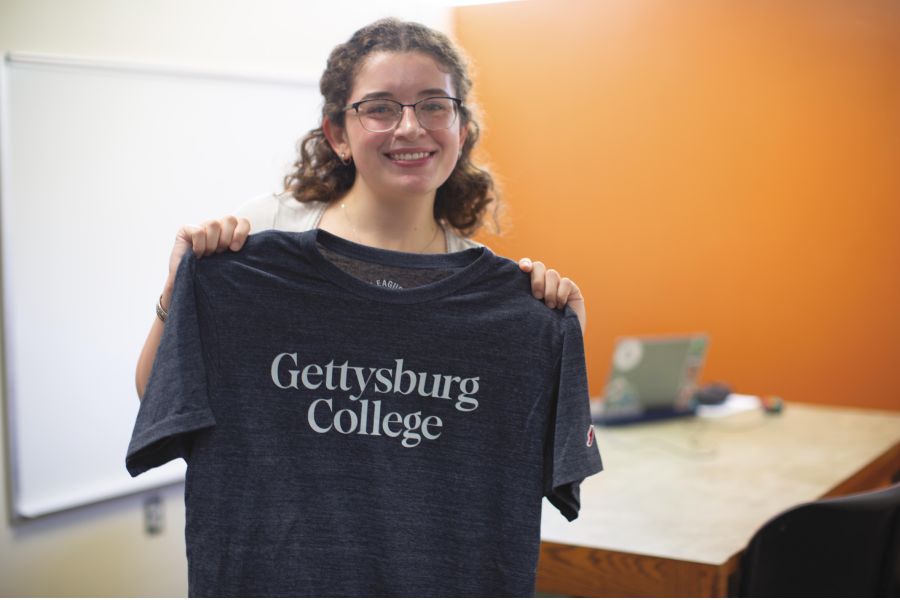 A student holding up the Gettysburg T-shirt