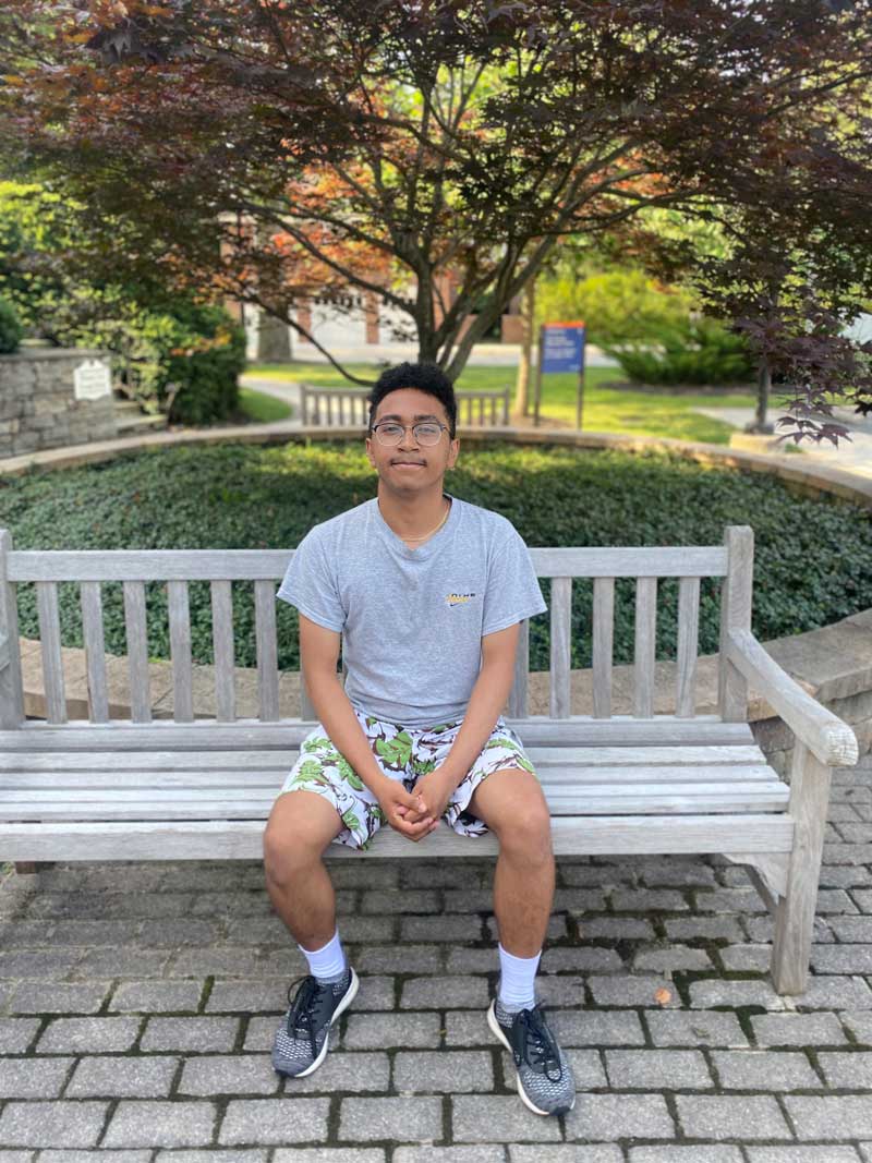 Andry Rakotonjanabelo sitting on a bench
